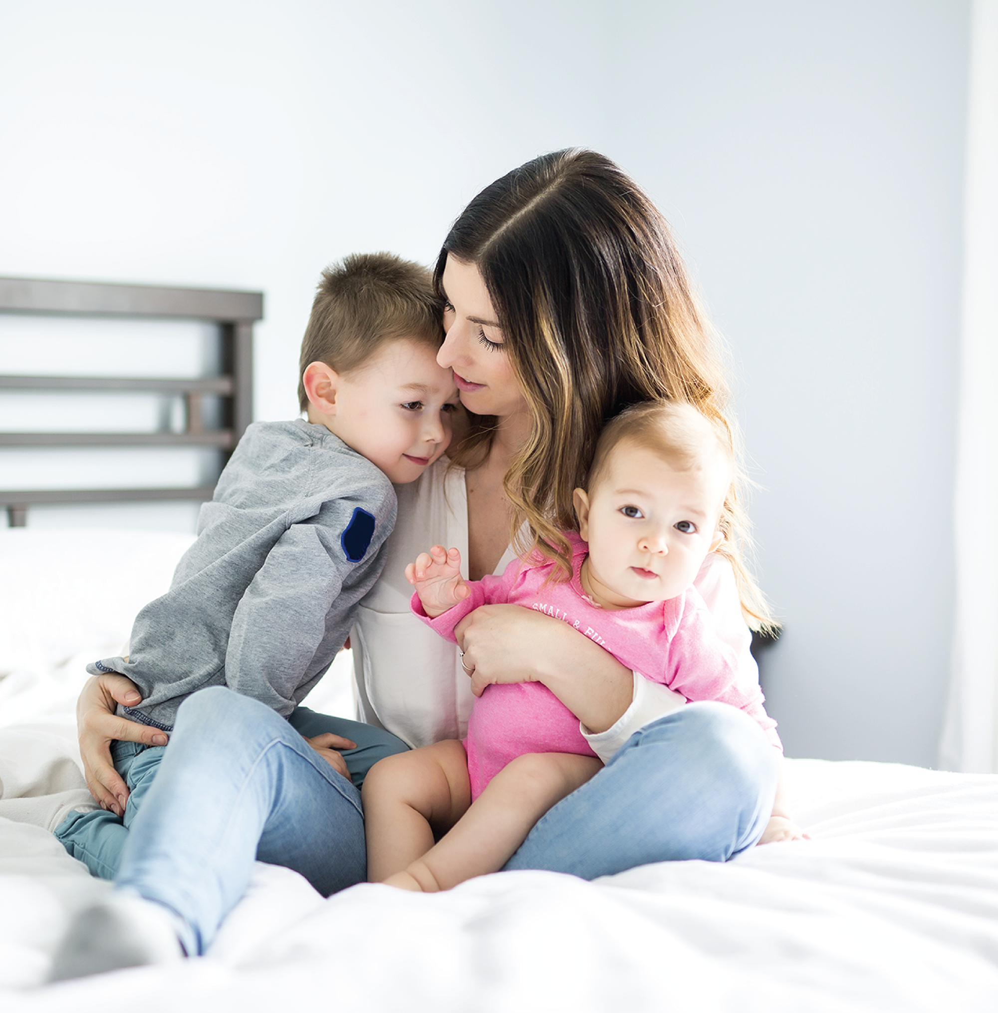 Mother hugging two kids