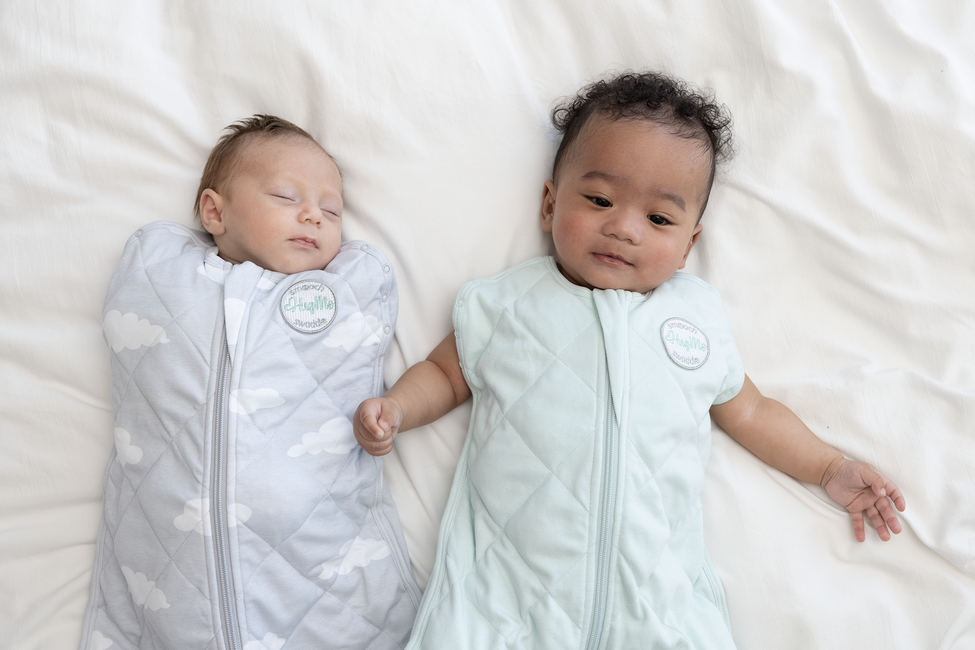 two children wrapped in weighted sleep sack and weighted swaddle